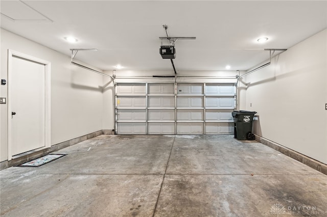 2750 Twin Lakes Dr, Troy, OH 45373 - garage with baseboards, a garage door opener, and recessed lighting