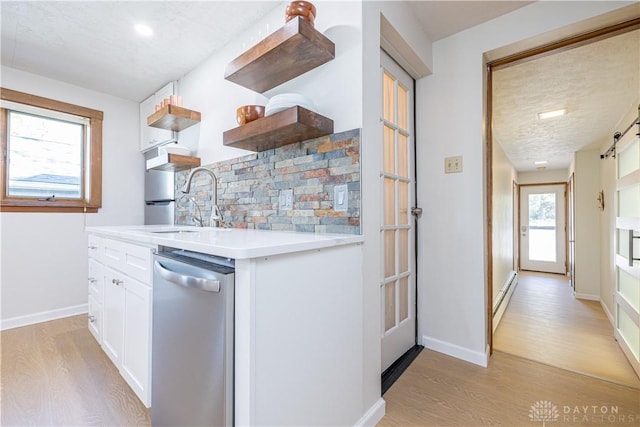 10125 Seminole Shore Dr, Huntsville, OH 43324 - kitchen with open shelves, light wood-style floors, stainless steel dishwasher, and white cabinets