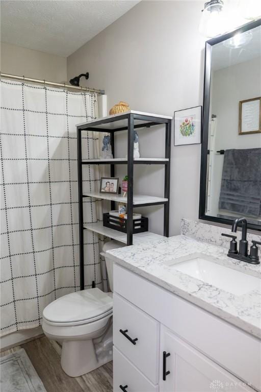 full bathroom featuring vanity, wood finished floors, toilet, and a shower with curtain