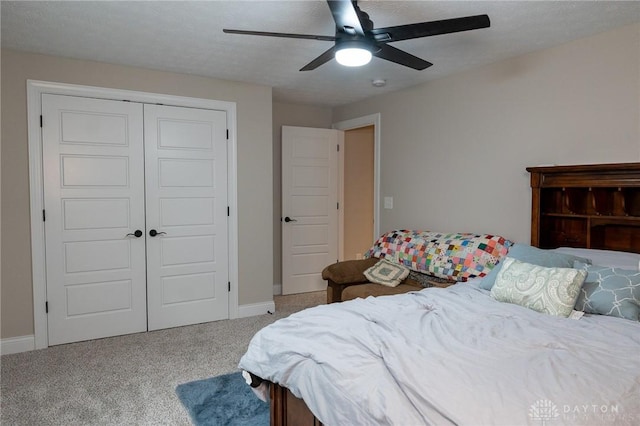 carpeted bedroom with a closet, a ceiling fan, and baseboards