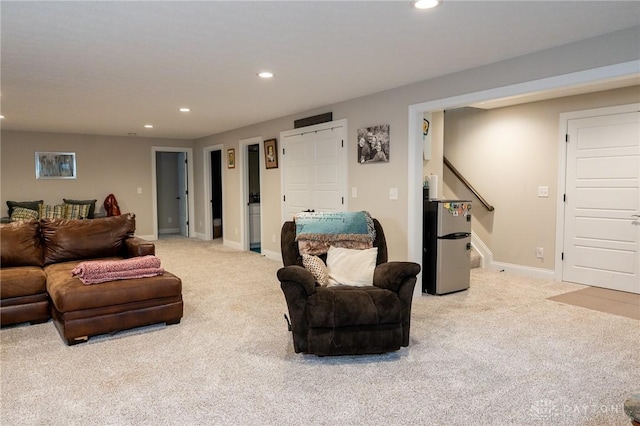 carpeted living room with recessed lighting, stairs, and baseboards
