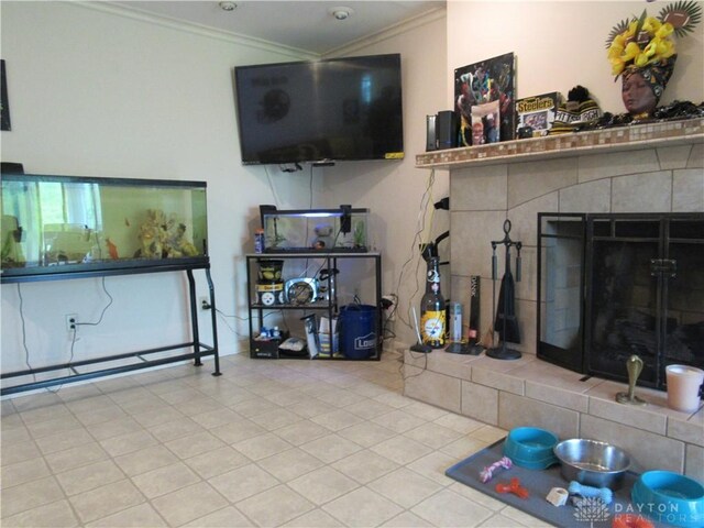 living area with crown molding, tile patterned floors, and a fireplace