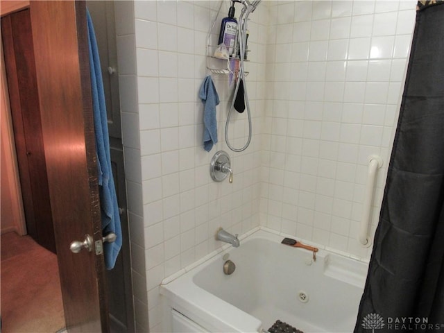 bathroom with shower / bath combo with shower curtain