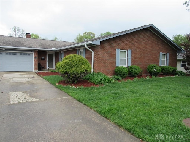 single story home featuring a front lawn, a chimney, brick siding, an attached garage, and driveway