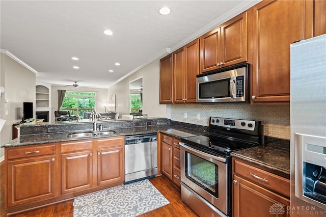 4266 Straight Arrow Rd, Beavercreek, OH 45430 - kitchen featuring crown molding, a sink, stainless steel appliances, open floor plan, and dark wood-type flooring