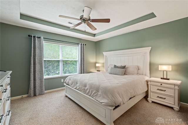 4266 Straight Arrow Rd, Beavercreek, OH 45430 - bedroom featuring a ceiling fan, a tray ceiling, light colored carpet, and baseboards