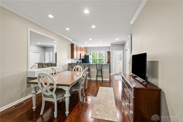 4266 Straight Arrow Rd, Beavercreek, OH 45430 - dining space with crown molding, recessed lighting, dark wood-style floors, and visible vents