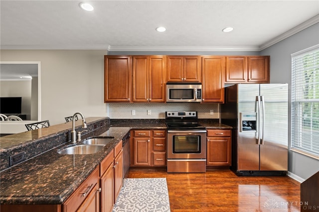 4266 Straight Arrow Rd, Beavercreek, OH 45430 - kitchen with a sink, appliances with stainless steel finishes, crown molding, and dark wood finished floors