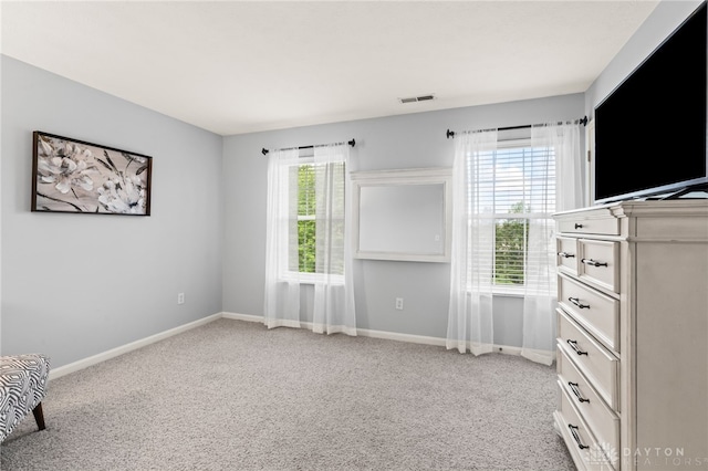 4266 Straight Arrow Rd, Beavercreek, OH 45430 - unfurnished bedroom with baseboards, visible vents, and light carpet