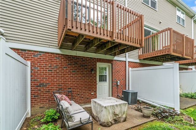 4266 Straight Arrow Rd, Beavercreek, OH 45430 - rear view of house featuring central air condition unit, fence, a wooden deck, and brick siding
