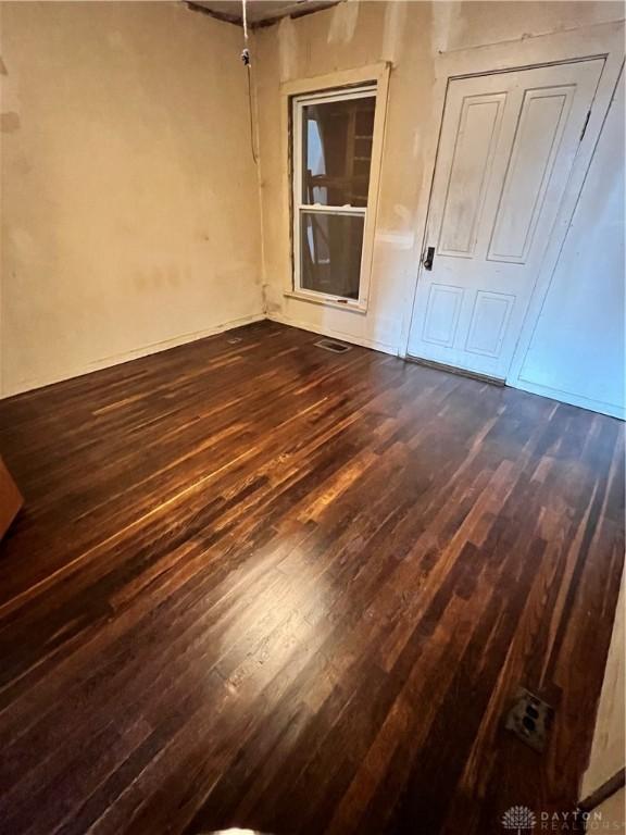 unfurnished room featuring dark wood finished floors