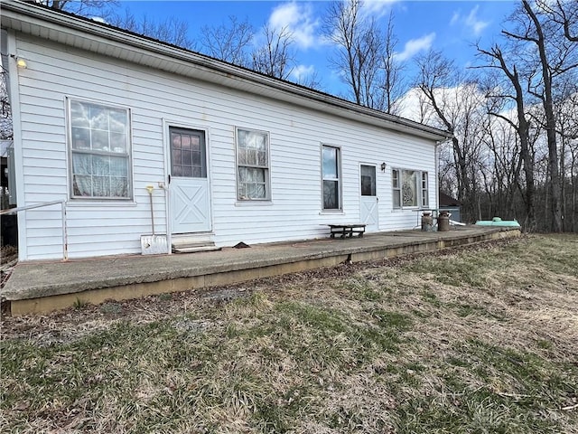 rear view of property featuring a yard