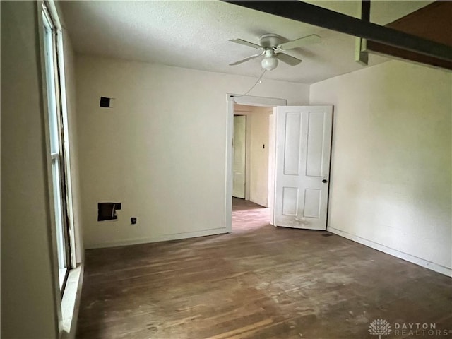 empty room featuring baseboards, ceiling fan, and wood finished floors