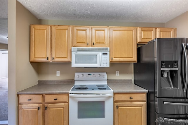 kitchen featuring white appliances and light brown cabinetry