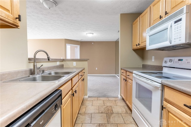 kitchen with light brown cabinetry, a textured ceiling, white appliances, a sink, and light countertops