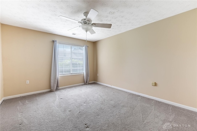empty room featuring carpet flooring, baseboards, and ceiling fan