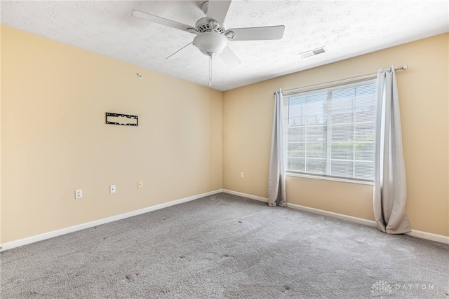 unfurnished room with visible vents, baseboards, ceiling fan, and carpet floors