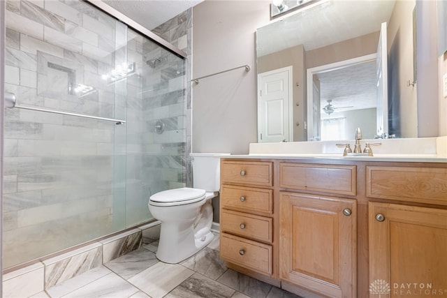 bathroom featuring toilet, a shower stall, vanity, and marble finish floor