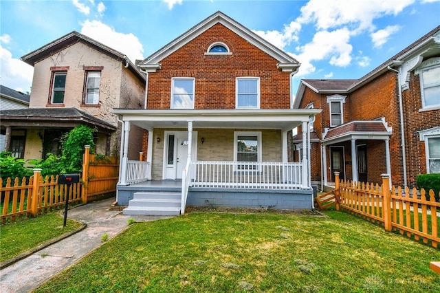 221 Linden Ave, Dayton, OH 45403 - traditional home featuring covered porch, fence, a front lawn, and brick siding