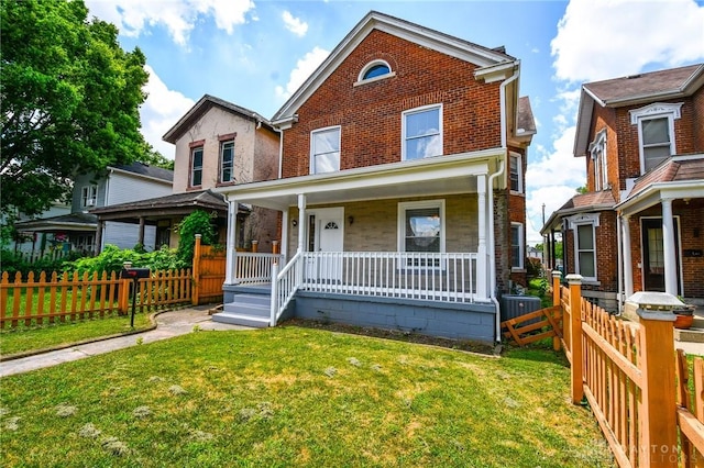 221 Linden Ave, Dayton, OH 45403 - traditional-style house featuring a porch, fence, and brick siding
