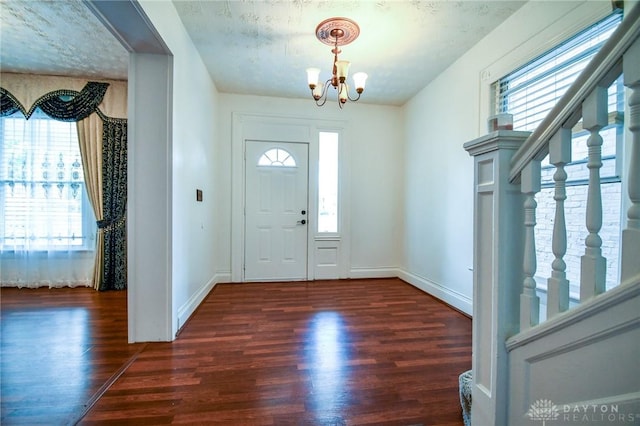 221 Linden Ave, Dayton, OH 45403 - entrance foyer featuring baseboards, a wealth of natural light, a notable chandelier, and wood finished floors