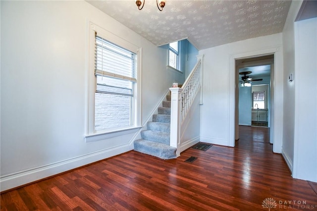 221 Linden Ave, Dayton, OH 45403 - stairway featuring a textured ceiling, a wealth of natural light, baseboards, and wood finished floors