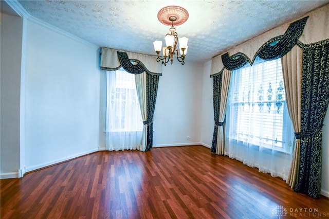 221 Linden Ave, Dayton, OH 45403 - spare room featuring an inviting chandelier, ornamental molding, a wealth of natural light, and wood finished floors