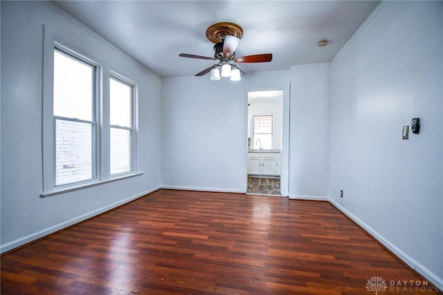 221 Linden Ave, Dayton, OH 45403 - spare room with baseboards, wood finished floors, a ceiling fan, and a sink