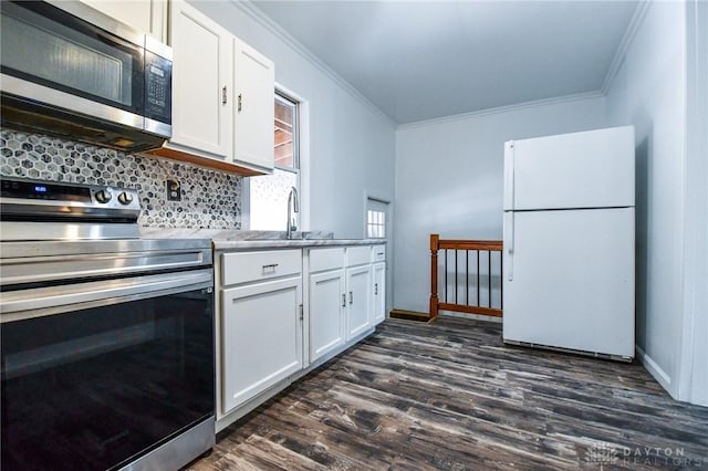 221 Linden Ave, Dayton, OH 45403 - kitchen with ornamental molding, a sink, white cabinetry, dark wood-type flooring, and appliances with stainless steel finishes