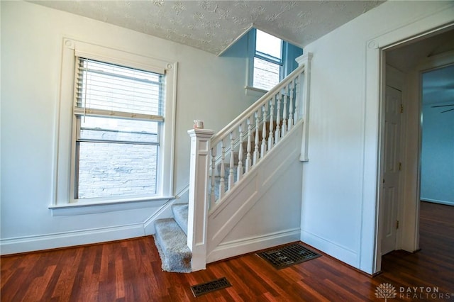 221 Linden Ave, Dayton, OH 45403 - staircase with baseboards, visible vents, a textured ceiling, and wood finished floors