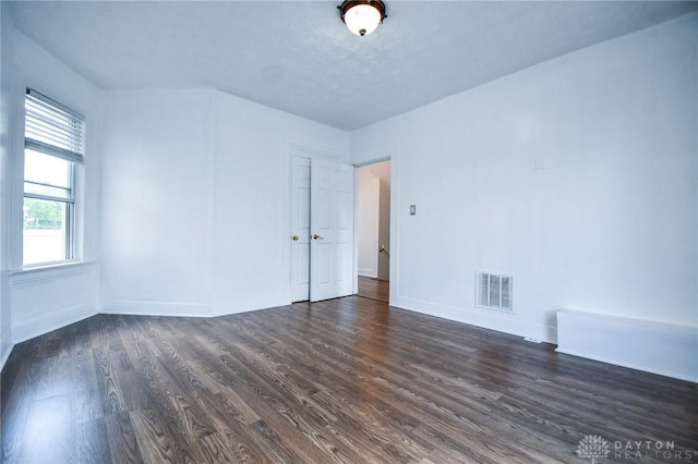 221 Linden Ave, Dayton, OH 45403 - empty room featuring baseboards, visible vents, and dark wood-type flooring