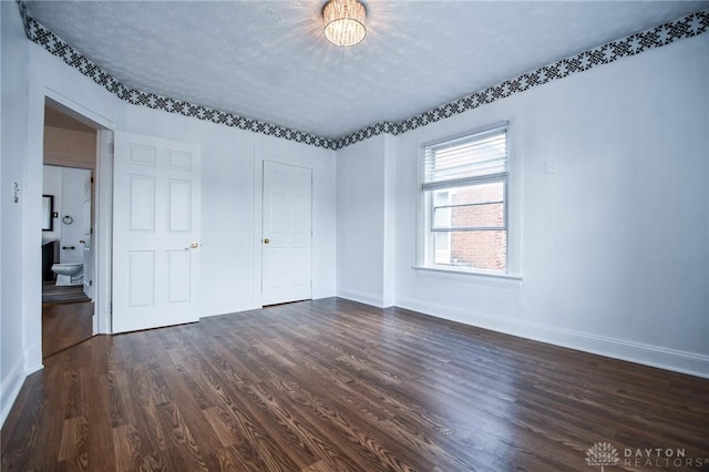 221 Linden Ave, Dayton, OH 45403 - unfurnished bedroom featuring baseboards and dark wood-style flooring