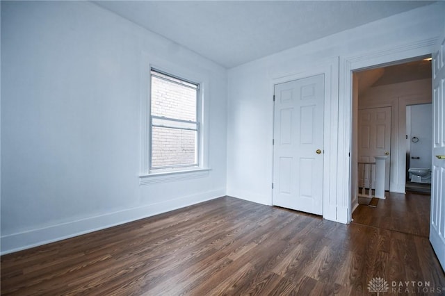 221 Linden Ave, Dayton, OH 45403 - unfurnished bedroom featuring baseboards and dark wood-style floors