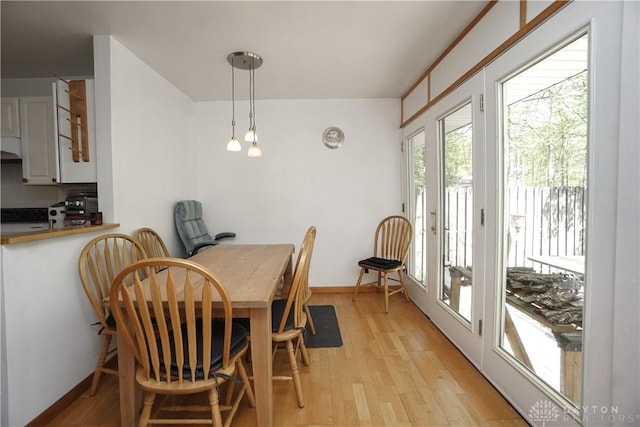 dining room with light wood-style floors and baseboards