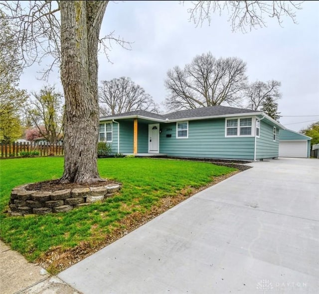 2004 N Reardon Dr, Dayton, OH 45420 - ranch-style home with an outdoor structure, a front lawn, fence, and a detached garage