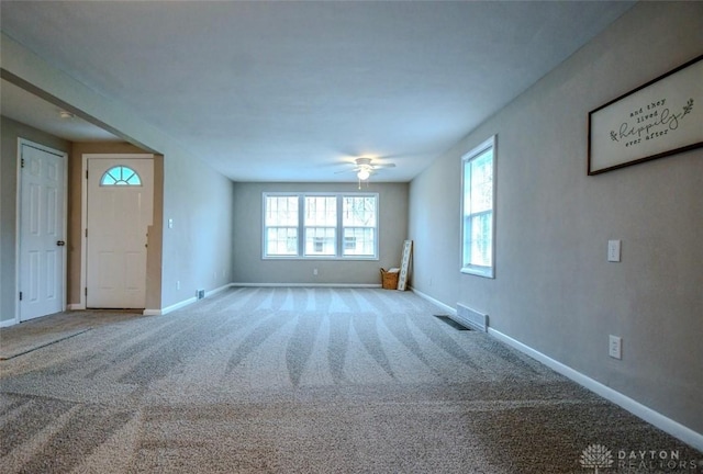 2004 N Reardon Dr, Dayton, OH 45420 - unfurnished living room with ceiling fan, carpet flooring, baseboards, and visible vents