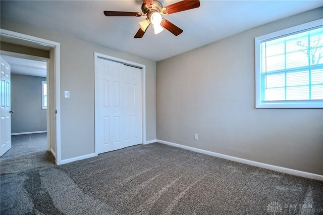 2004 N Reardon Dr, Dayton, OH 45420 - unfurnished bedroom with carpet flooring, a closet, baseboards, and ceiling fan