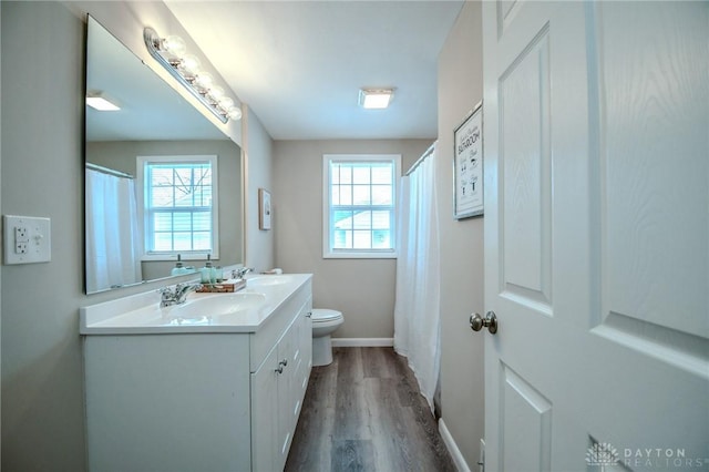 2004 N Reardon Dr, Dayton, OH 45420 - full bath with toilet, baseboards, plenty of natural light, and wood finished floors