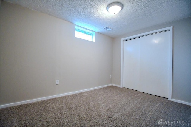 2004 N Reardon Dr, Dayton, OH 45420 - unfurnished bedroom with a closet, a textured ceiling, visible vents, carpet floors, and baseboards