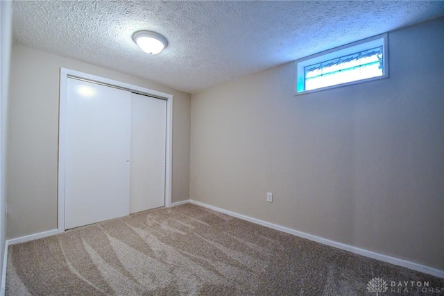 2004 N Reardon Dr, Dayton, OH 45420 - unfurnished bedroom featuring carpet, a textured ceiling, a closet, and baseboards