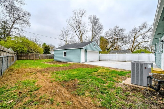 2004 N Reardon Dr, Dayton, OH 45420 - view of yard featuring a patio, central air condition unit, a fenced backyard, an outbuilding, and a detached garage