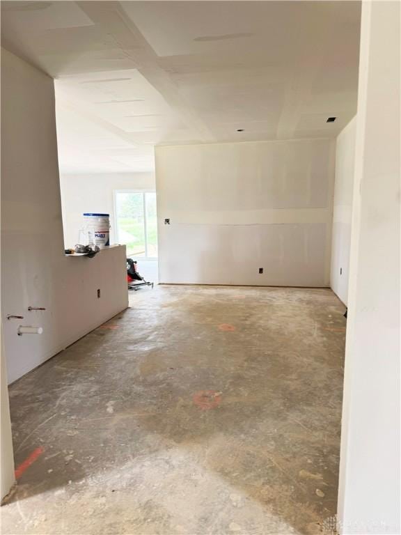 unfurnished room with concrete flooring