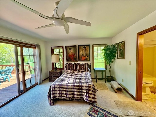 carpeted bedroom featuring access to outside, baseboards, and multiple windows