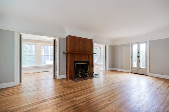 825 Far Hills Ave, Oakwood, OH 45419 - unfurnished living room with light wood finished floors, plenty of natural light, a large fireplace, and baseboards