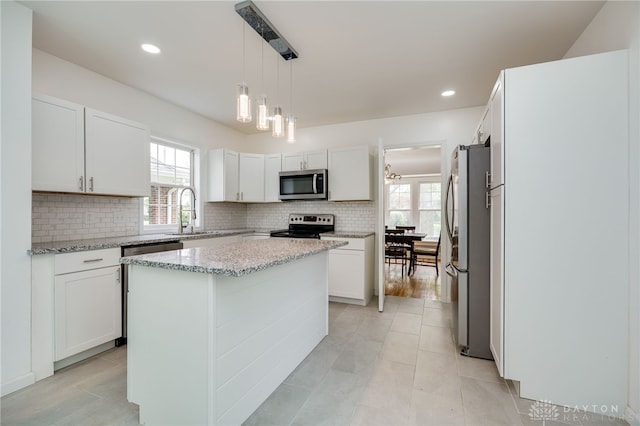 825 Far Hills Ave, Oakwood, OH 45419 - kitchen featuring stainless steel appliances, a sink, backsplash, white cabinetry, and light stone countertops
