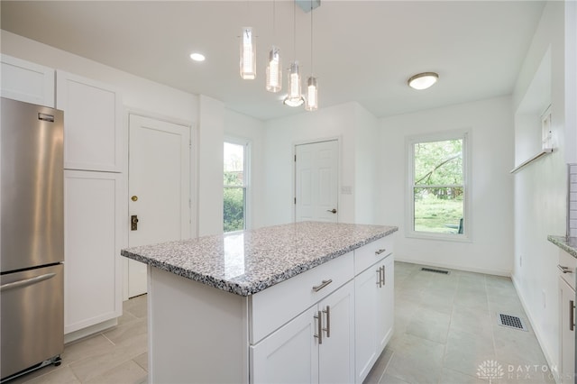 825 Far Hills Ave, Oakwood, OH 45419 - kitchen with freestanding refrigerator, light stone counters, a kitchen island, pendant lighting, and recessed lighting