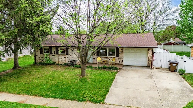 1579 Commonwealth Dr, Xenia, OH 45385 - view of front of property featuring brick siding, a garage, concrete driveway, and a gate