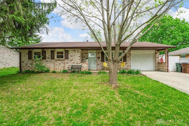 1579 Commonwealth Dr, Xenia, OH 45385 - ranch-style home with a garage, brick siding, concrete driveway, and a front lawn