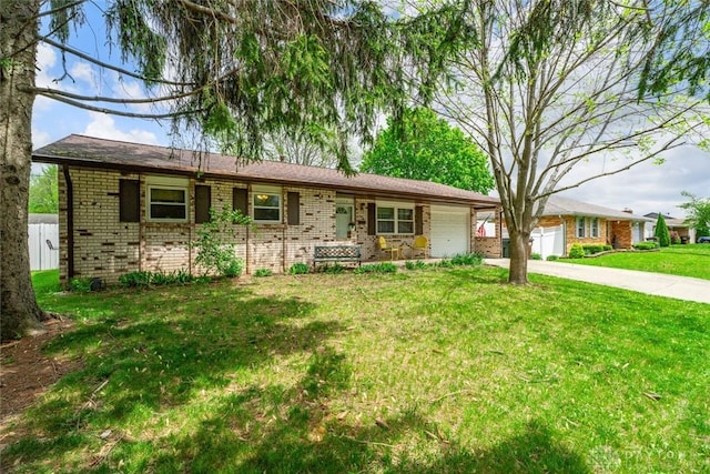 1579 Commonwealth Dr, Xenia, OH 45385 - single story home with a garage, brick siding, driveway, and a front yard
