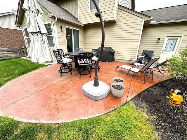 view of patio / terrace featuring outdoor dining space and a grill
